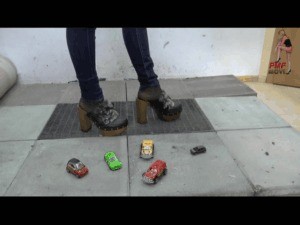 Cars Crushed Under Wooden Clog